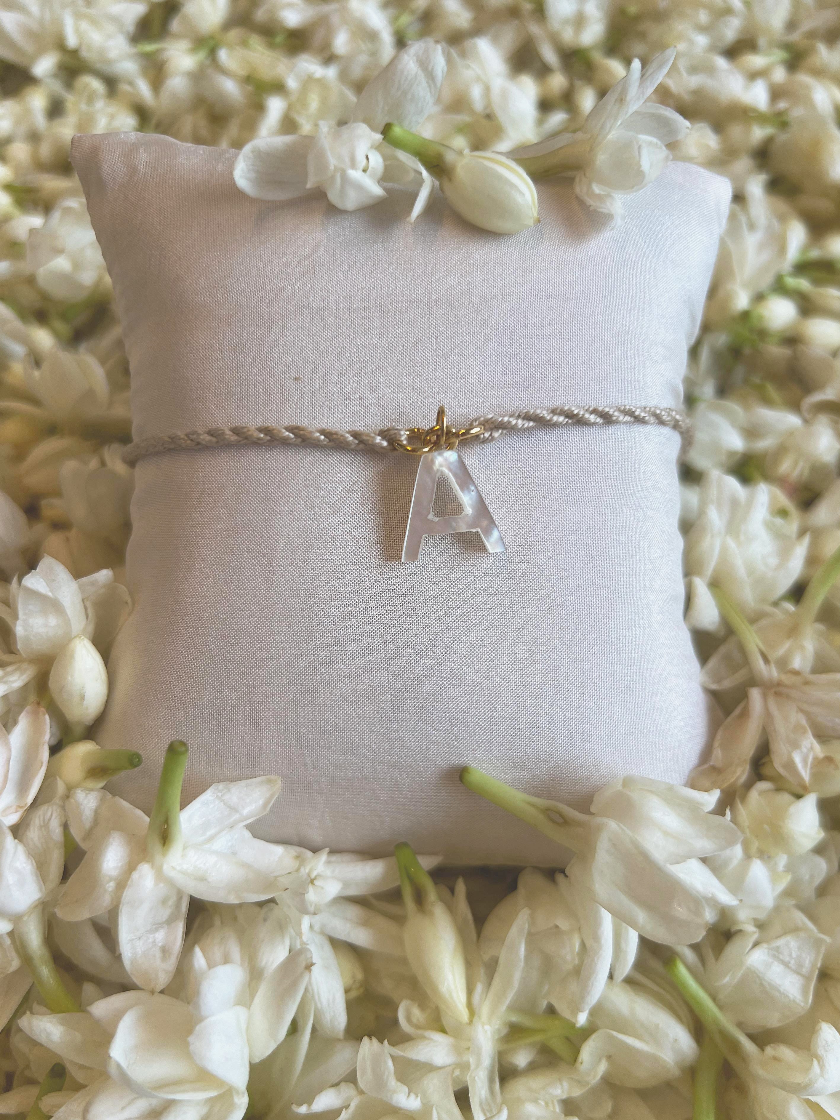 aras - Mother of Pearl Akshara Charm Rakhi