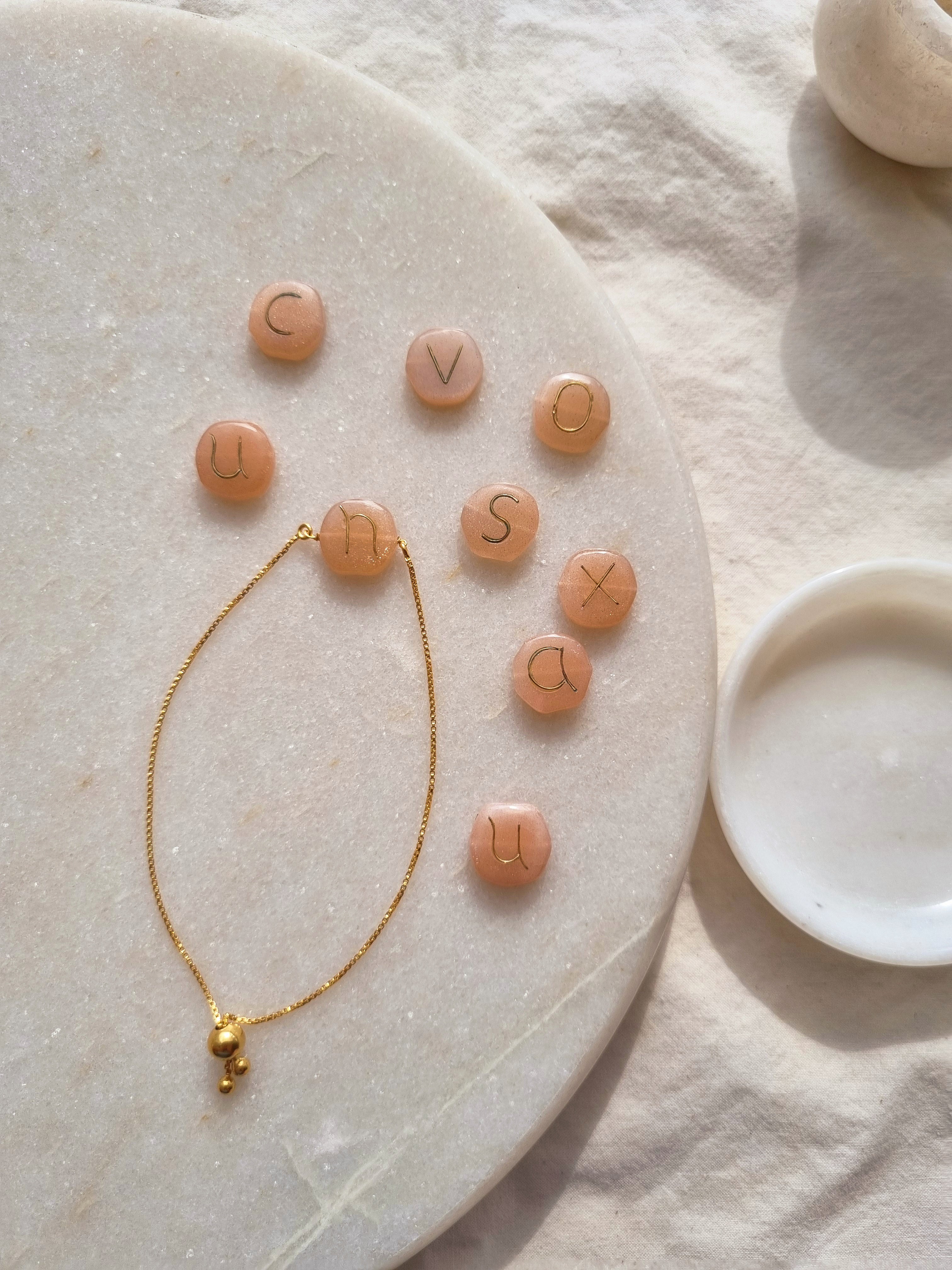 madana- Peach Moonstone Pebble with Embossed Initial Bracelet