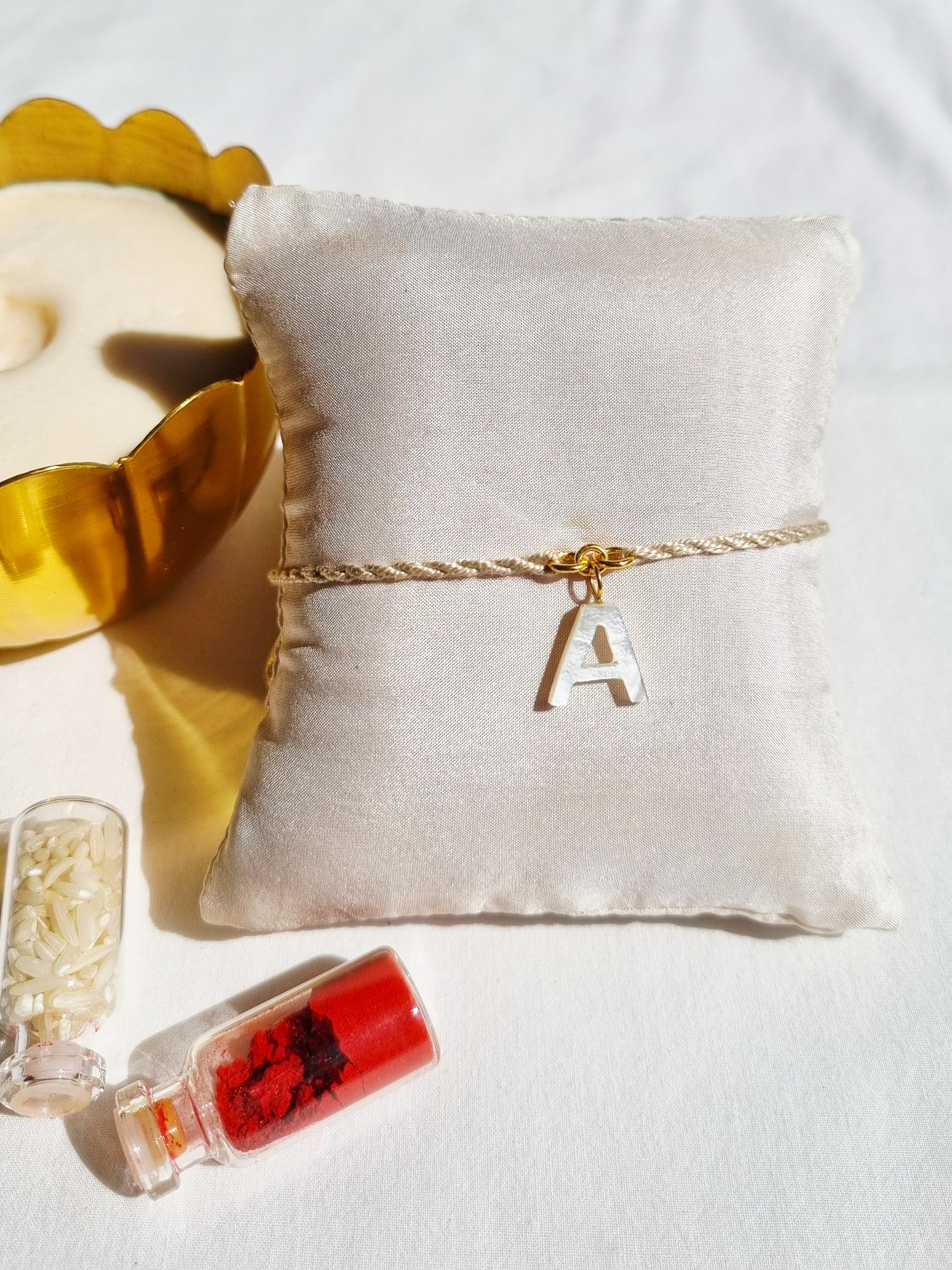 aras - Mother of Pearl Akshara Charm Rakhi