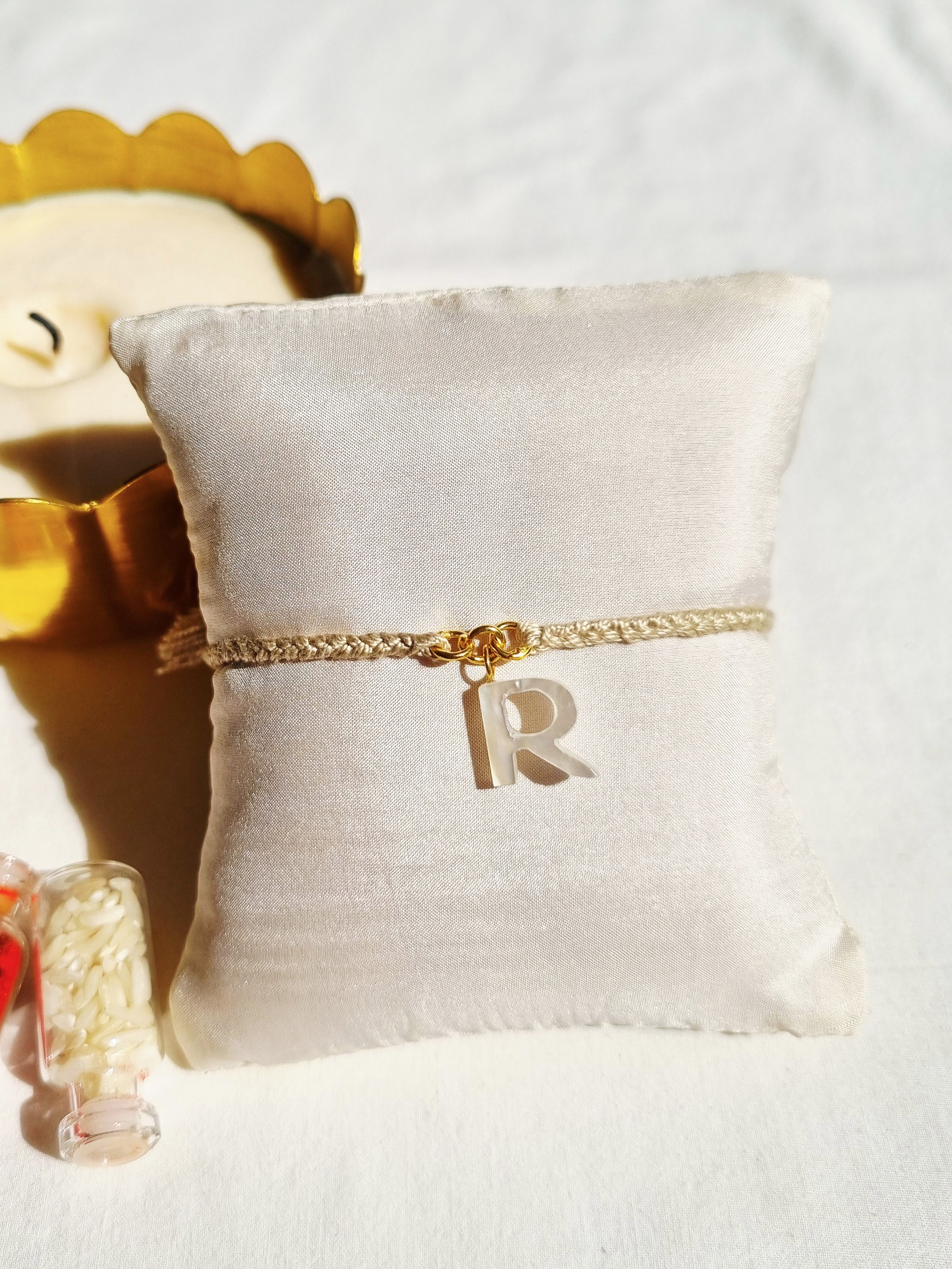 aras - Mother of Pearl Akshara Charm Rakhi