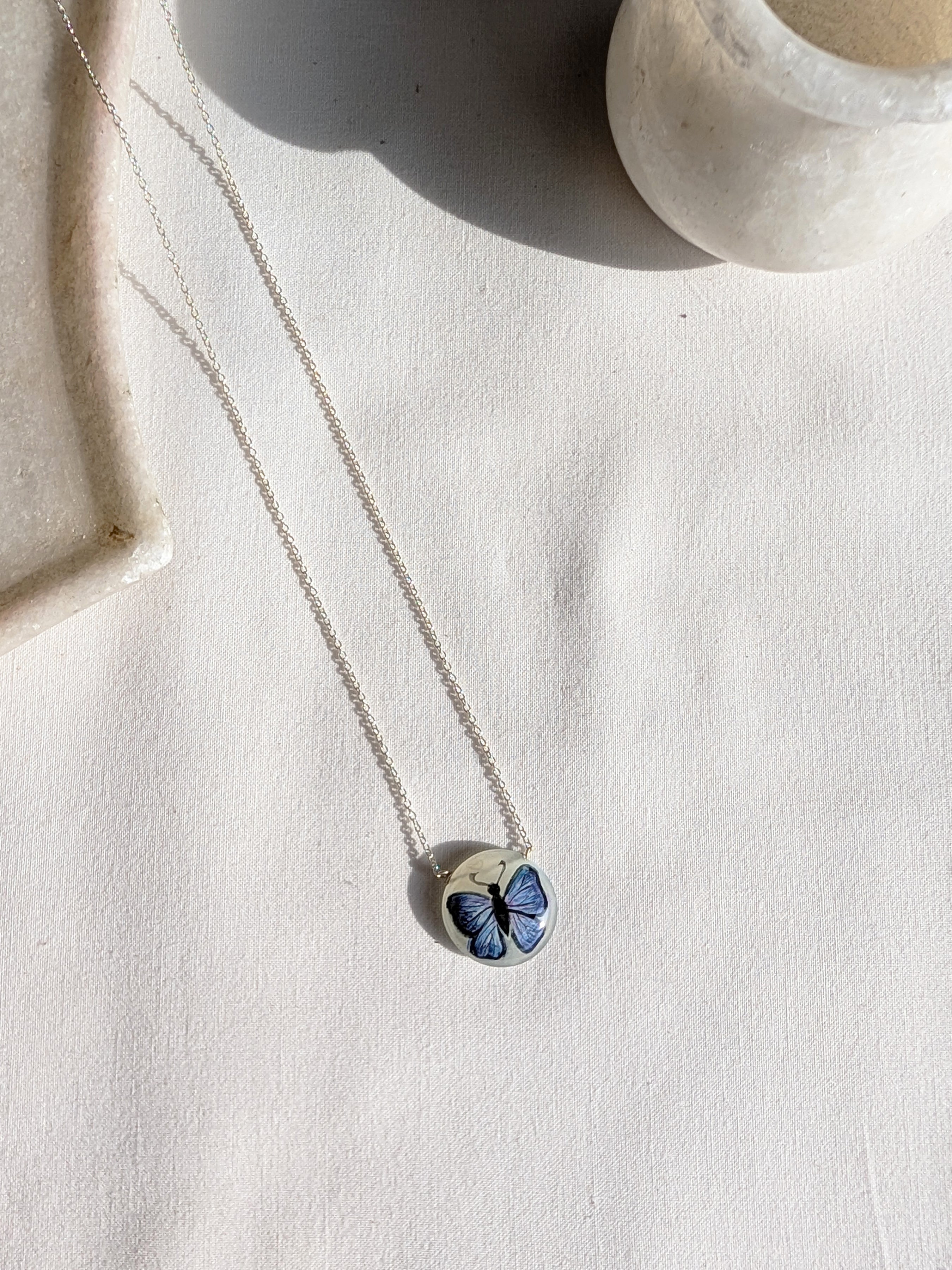 titálee - Butterfly hand painted on Moonstone